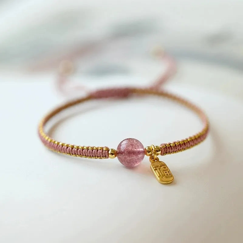Adjustable red rope bracelet with transfer beads in Strawberry Quartz style on a wrist.