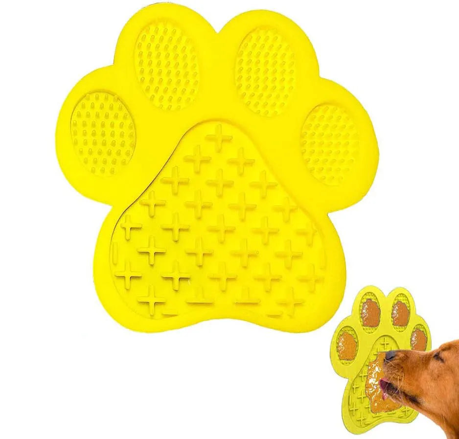 Bone-shaped blue silicone dog licking mat with suction cups on a tile surface