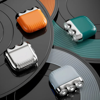Mini electric shaver with three floating heads in gun colour, orange, green, or blue options