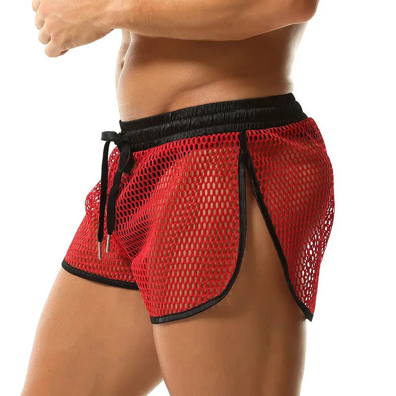 Men's solid colour loose fit polyester boxer shorts shown in black, white, grey, and red.
