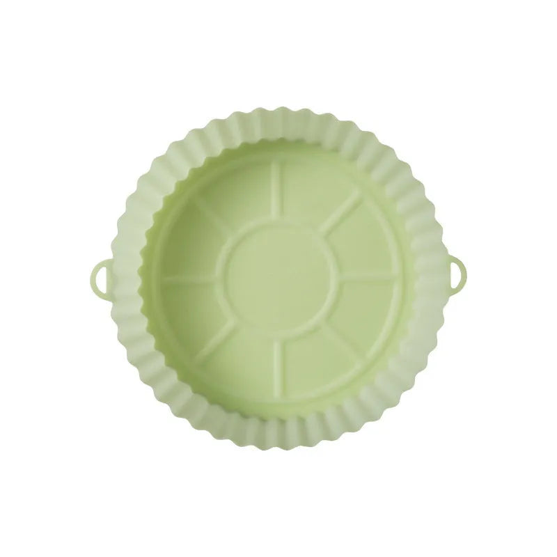 Round blue silicone baking tray mat with 4.5cm sides on a kitchen counter.