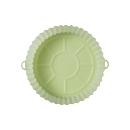 Round blue silicone baking tray mat with 4.5cm sides on a kitchen counter.