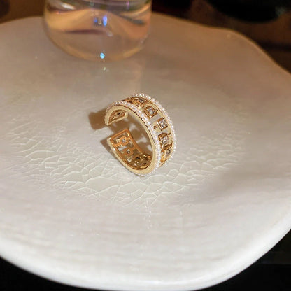 Elegant square ring with hollowed-out design and shimmering zircon stones, perfect for the stylish British woman