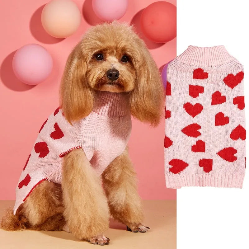 Dog wearing red love heart design sweater with bow decoration