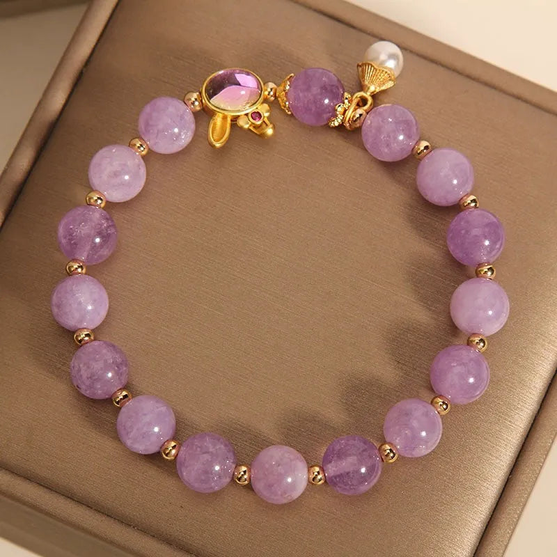 Natural mauve jade rabbit head charm bracelet with crystal details on wrist.