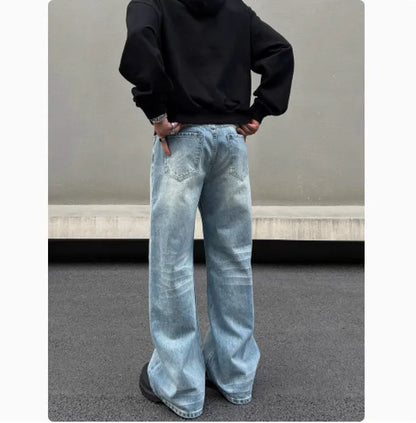 Men's blue straight leg jeans with whisker distressing and flared leg cut