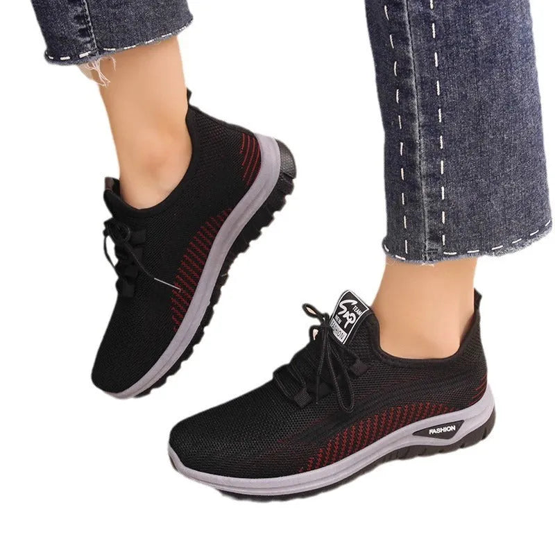 Women's black breathable mesh sneakers with round toe and cross strap lace-up detail