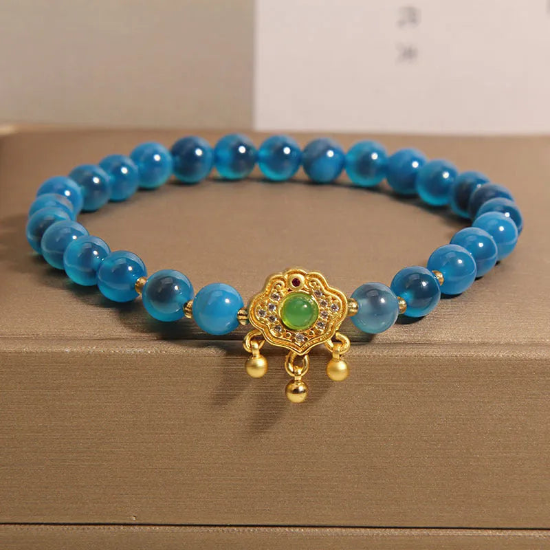 Blue sugar heart agate safety lock pendant on a women's crystal bracelet with alloy inlay and rhinestones.