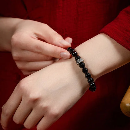 Obsidian bead bracelet with zodiac animal and Buddhist bodhisattva inlay designs.