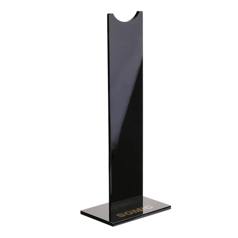 Pink and black detachable headset stand with non-slip silicone base on a desk.