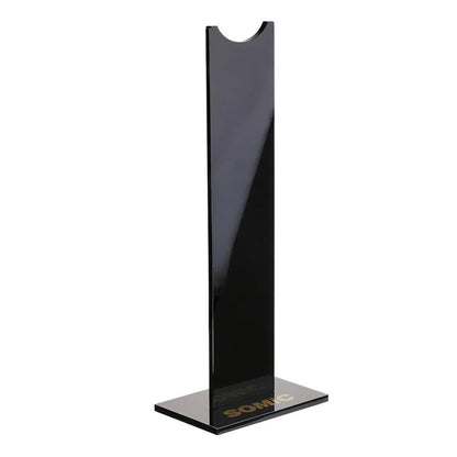 Pink and black detachable headset stand with non-slip silicone base on a desk.