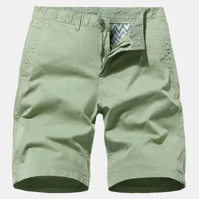 Man wearing blue denim loose-fit casual shorts with an elasticated waist, no belt.