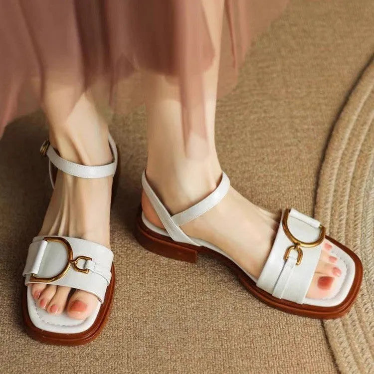 Women's black thick-soled casual sandals with round toe and a single button fastening across the instep.