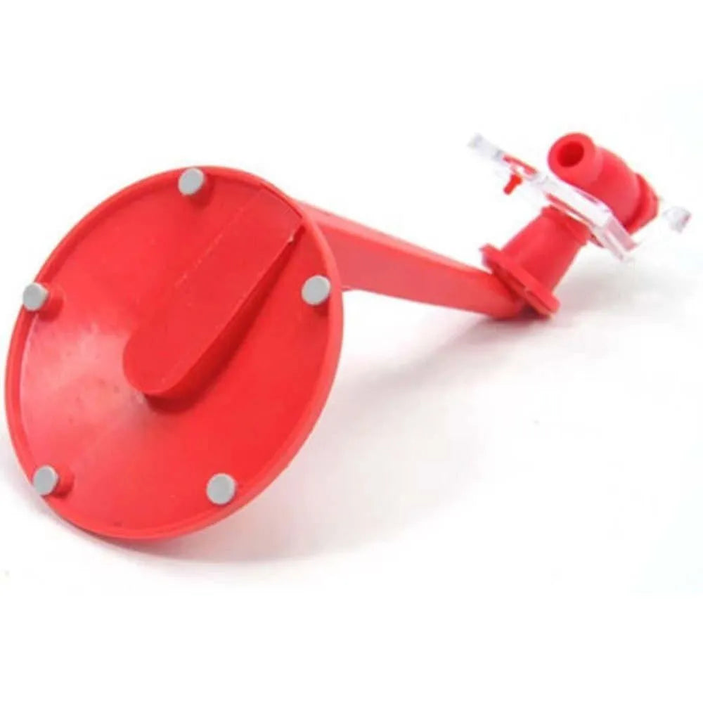 Red plastic Magic Tap soda bottle dispenser attached to an inverted 2-litre bottle on a kitchen table.