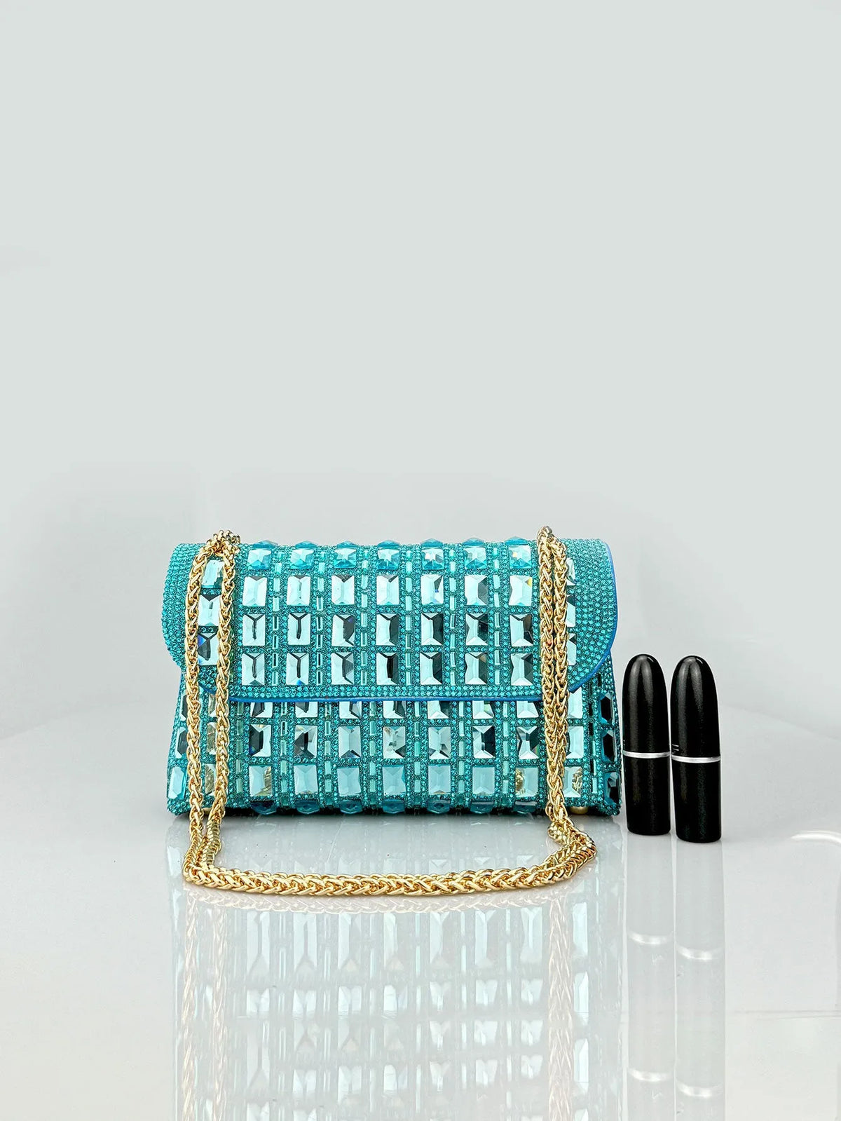 Silver rhinestone-decorated PU leather clutch bag with a metal chain strap, shown open to reveal interior phone pocket.