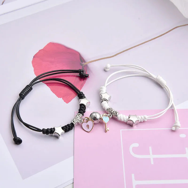 A pair of magnet couple bracelets with a suction clasp, showing various design options like clovers, crowns, and hearts.
