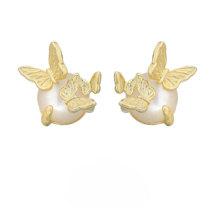 Close-up of a pair of 925 silver butterfly ear studs with gold plating, showing detailed animal zodiac modelling.