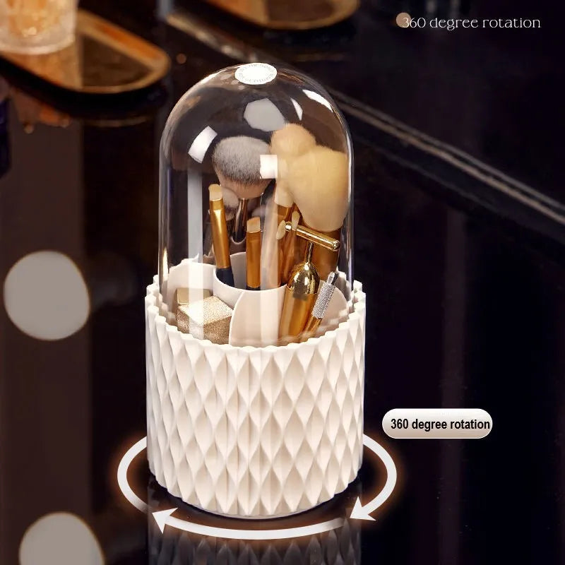 White rotating acrylic makeup brush holder with transparent dustproof lid on a desktop.