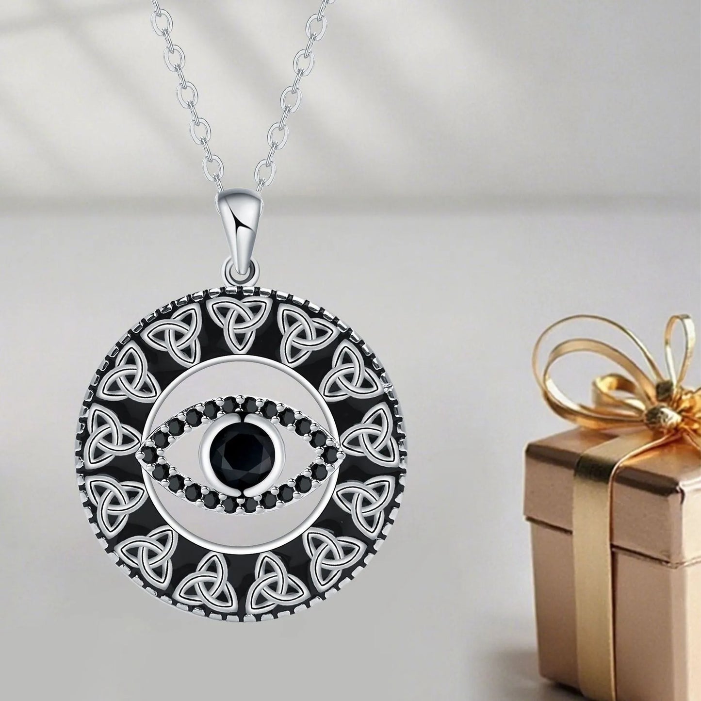 Close-up of a women's copper Devil's Eye pendant necklace on a cross chain, showing electroplated finish.