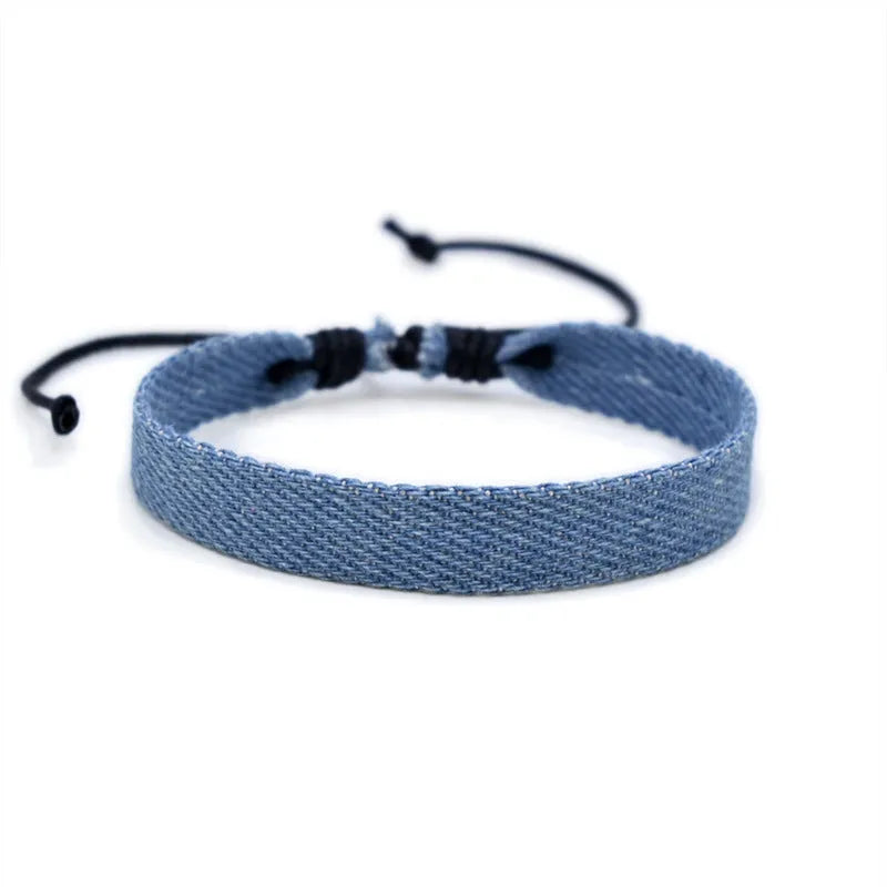 National style denim fabric bracelet carrying strap showing mixed material construction and wristband design