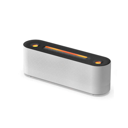 Black ultrasonic humidifier diffuser emitting cool mist with multi-colour LED flame light effect on a wooden surface.