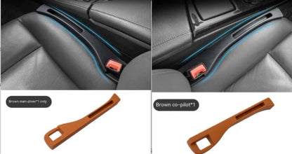 Black car seat gap storage box organiser with compartments and carrying handle between vehicle seats