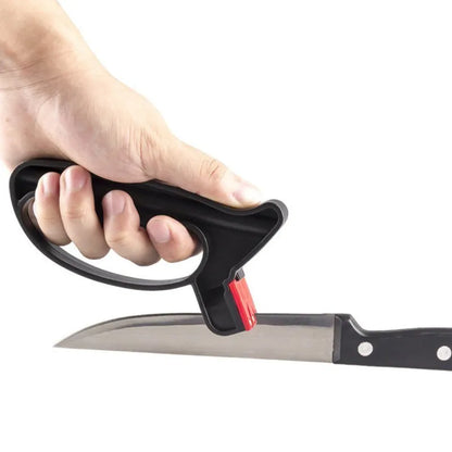 Black handheld knife and scissor sharpener with ergonomic grip, showing tungsten steel grindstone slot.