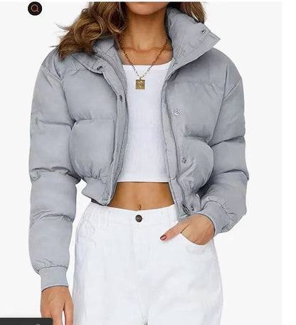 Loose blue polyester jacket for women on a hanger, showing long sleeves and front zip.