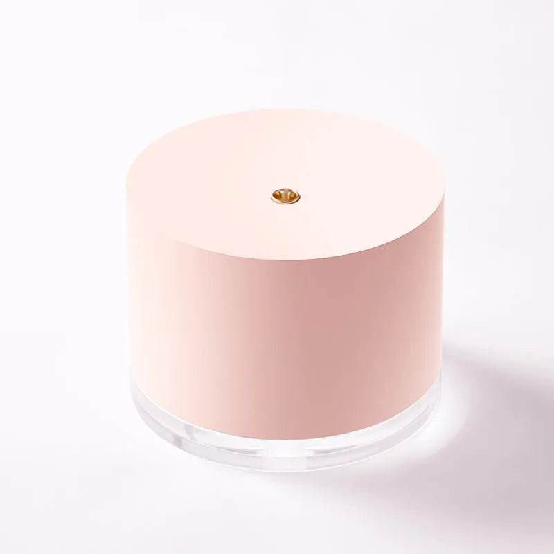 White portable ultrasonic humidifier with LED light and USB charging port on a wooden surface.
