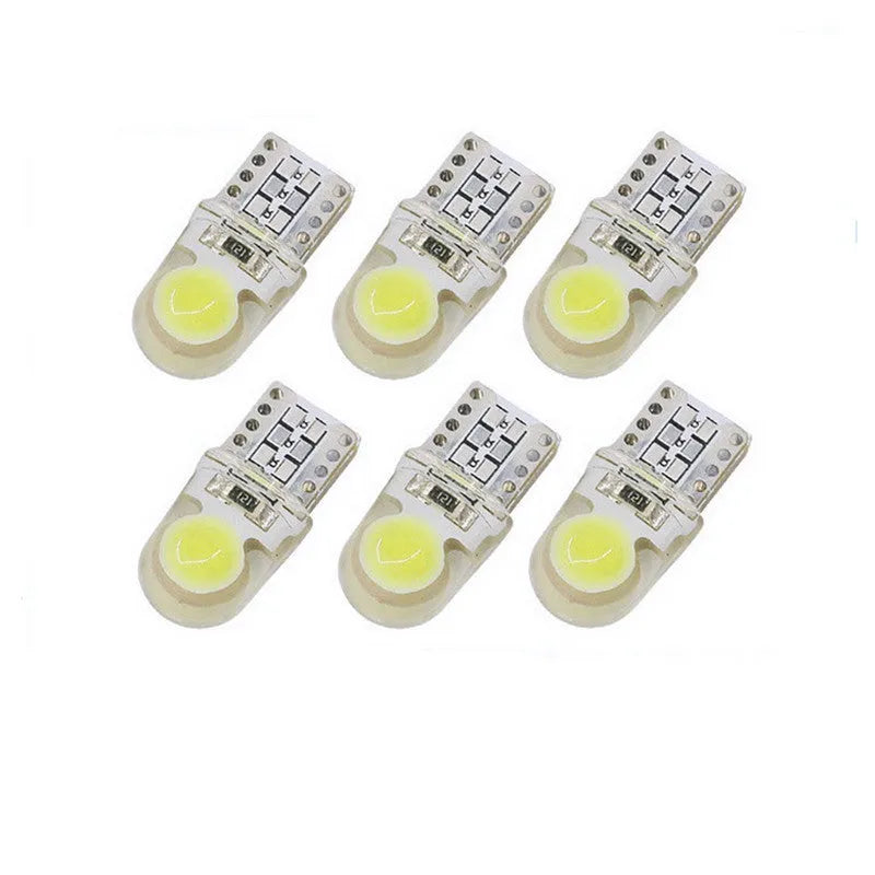 Pack of ten T10 wedge base LED car bulbs with COB chips in various colours on a white background