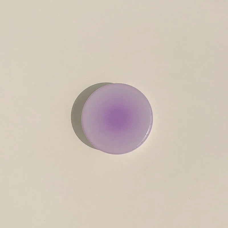 Yellow and purple gradient silicone iPhone case showing integrated airbag X bracket on the back.