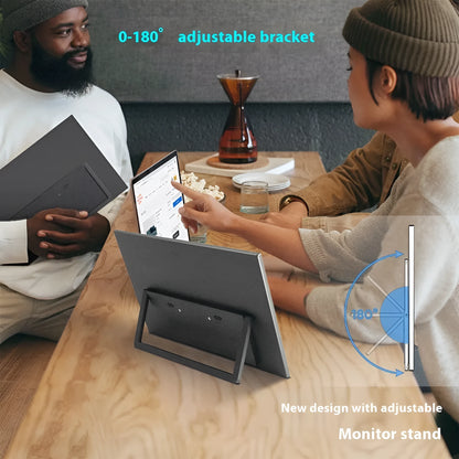 Black 15.6-inch portable USB-C monitor with adjustable stand on a desk, showing a desktop application.