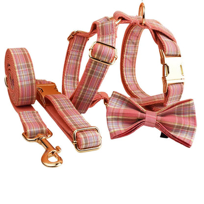 Red plaid cloth dog collar and leash set with matching bow on a white background