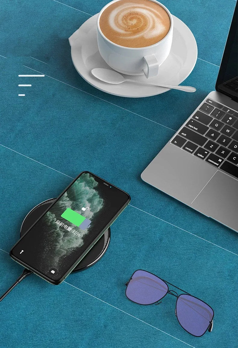 Black circular wireless charging disc for mobile phones with indicator light