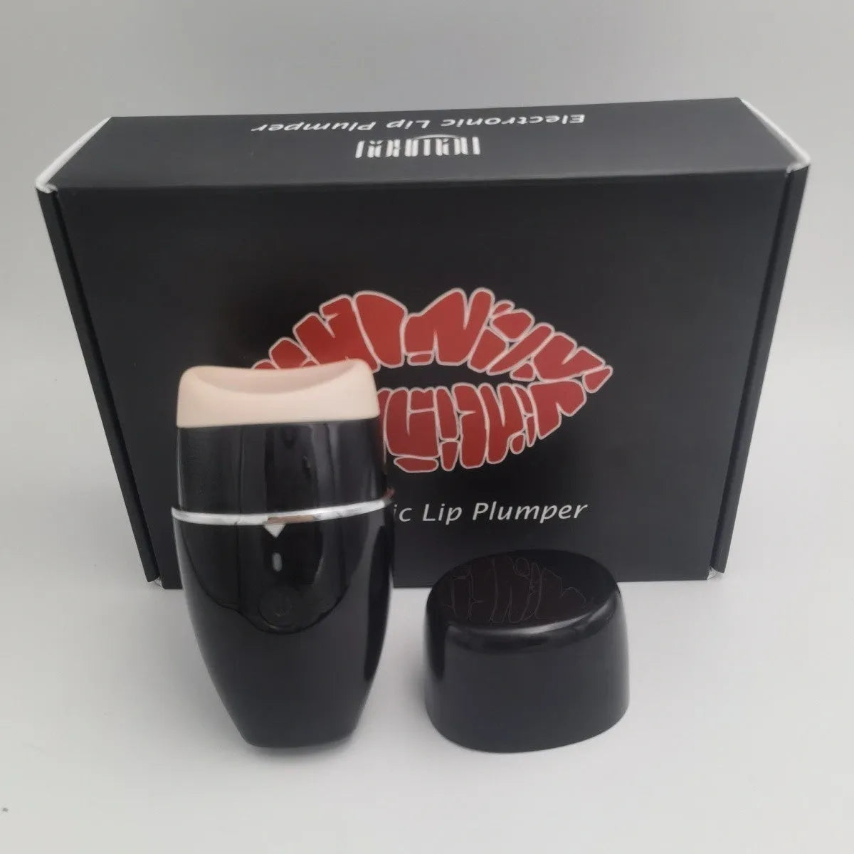 Black and white electric silicone lip plumper with 3-speed adjustment and USB charging cable