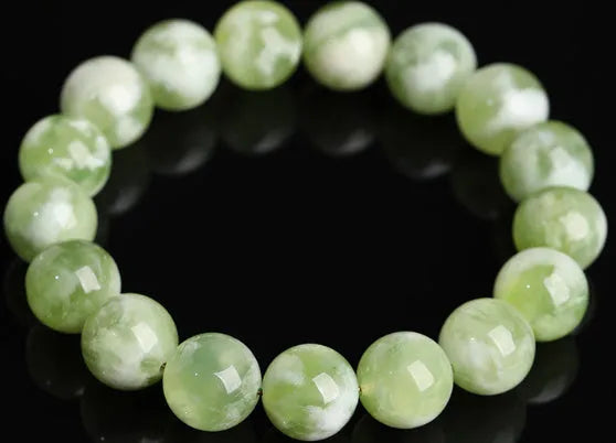 Green milk-in-water Xiuyan jade bracelet with polished geometric beads.