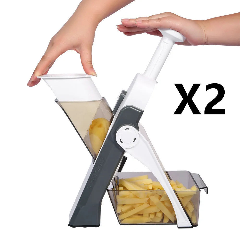 Orange multifunctional vegetable cutter kitchen tool with mandoline blades on a countertop.