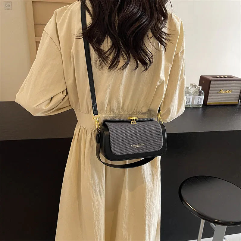 Women's PU leather messenger bag in a horizontal square shape with a lock and adjustable shoulder strap.