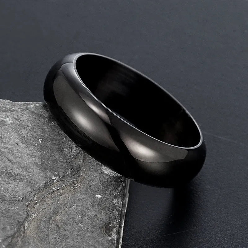Glossy electroplated titanium steel ring in black, gold, or steel colour on finger