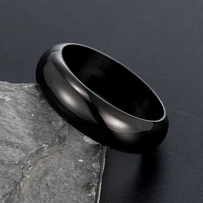 Glossy electroplated titanium steel ring in black, gold, or steel colour on finger