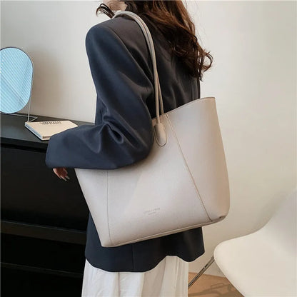 PU leather soft bucket shoulder tote bag with synthetic leather lining, outer sandwich pocket and zipper change bag