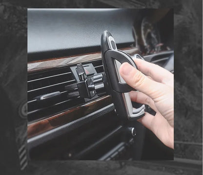 Black universal car air vent mobile phone holder attached to a vehicle vent, showing adjustable arms and 360-degree rotation.