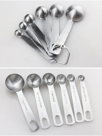 Set of six stainless steel measuring spoons connected by a silver D-ring, showing engraved measurement markings