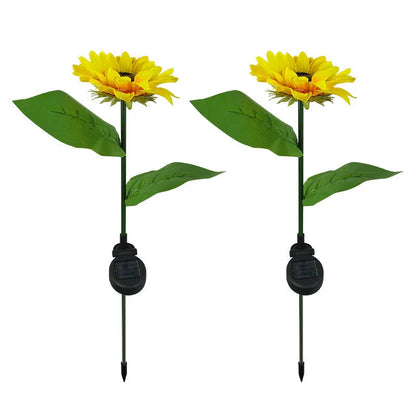 Elegant solar-powered sunflower lamps illuminating a serene outdoor garden pathway