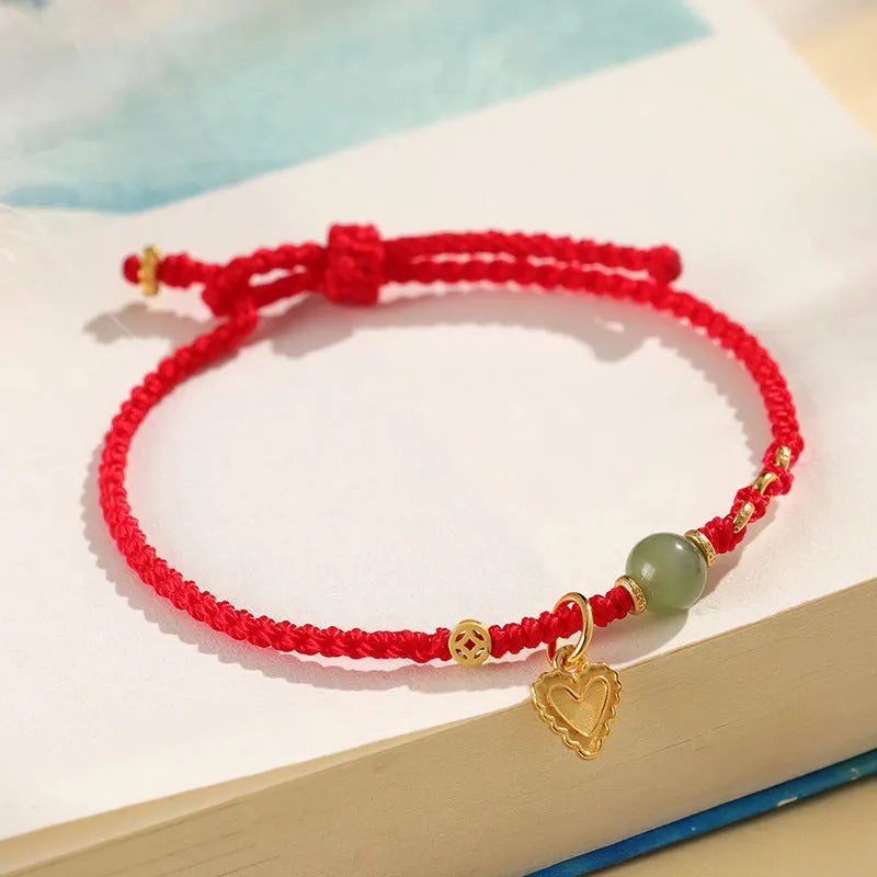 Handmade women's bracelet with 925 silver and Hetian jade in woven design with red carrying strap
