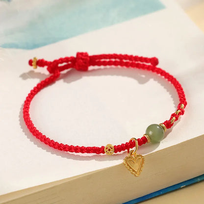 Handmade women's bracelet with 925 silver and Hetian jade in woven design with red carrying strap