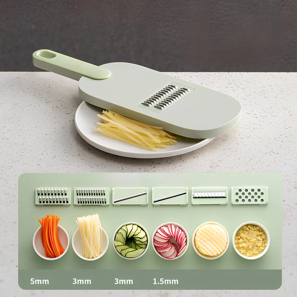 Shredded vegetable slicer with stainless steel blades on green cutting board
