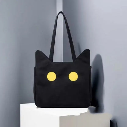 Black cat-shaped nylon tote bag with medium-soft structure, nylon lining, and sandwich zipper pocket, 34cm x 13cm x 27cm.