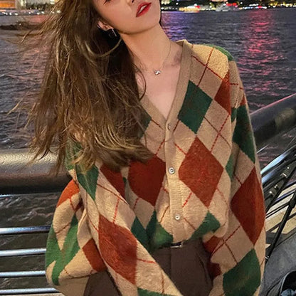 Long sleeve knitted cardigan in a light khaki colour, shown open over a white top, demonstrating its relaxed fit and medium weight.