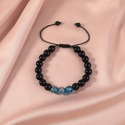 Adjustable luminous beaded bracelet with geometric glass beads on a stretchy elastic band in sapphire blue